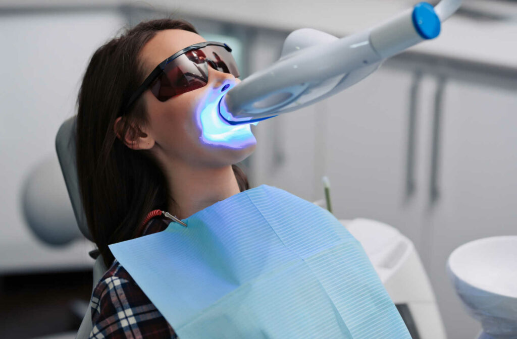 A young lady undergoing teeth bleaching to whiten her teeth at the  Dentist's clinic.