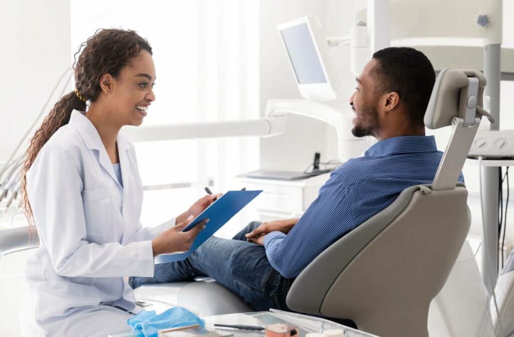 A dentist describes to a patient how good oral health habits can prevent the need for a root canal in the future.